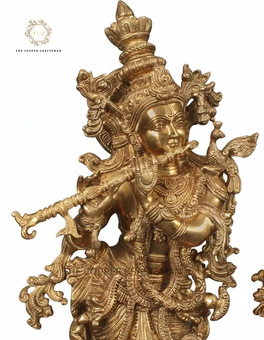 Gold-colored deity statue with intricate details on a white background