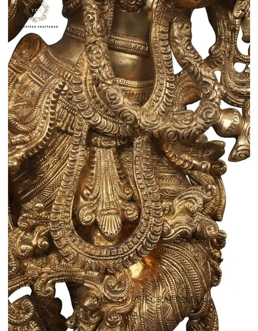 Decorative brass sculpture with intricate designs on a white background