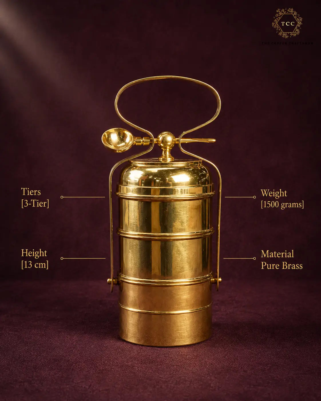 A polished brass 3-tier tiffin box with a carrying handle, shown on a dark burgundy background with text callouts indicating dimensions, weight, and material.