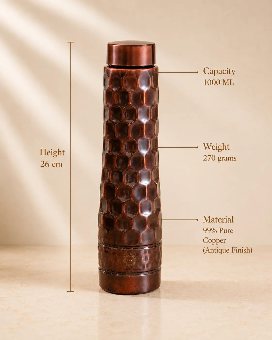 A Antique Diamond Copper Water Bottle shown on a beige background with measurement annotations indicating a height of 26 cm, capacity of 1000 mL, weight of 270 grams, and material as 99% pure copper antique finish.