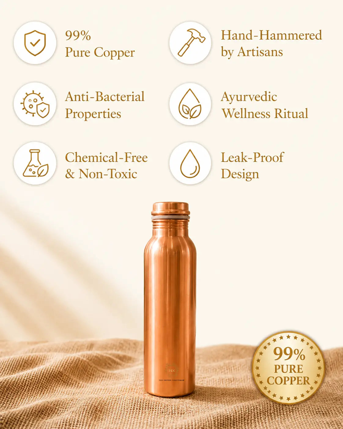 A Classic 1 litre pure copper water bottle stands on a textured beige fabric surface against a warm cream background. Surrounding the bottle are feature callouts with icons and text reading '99% Pure Copper,' 'Hand-Hammered by Artisans,' 'Anti-Bacterial Properties,' 'Ayurvedic Wellness Ritual,' 'Chemical-Free & Non-Toxic,' and 'Leak-Proof Design,' plus a gold seal that says '99% Pure Copper.