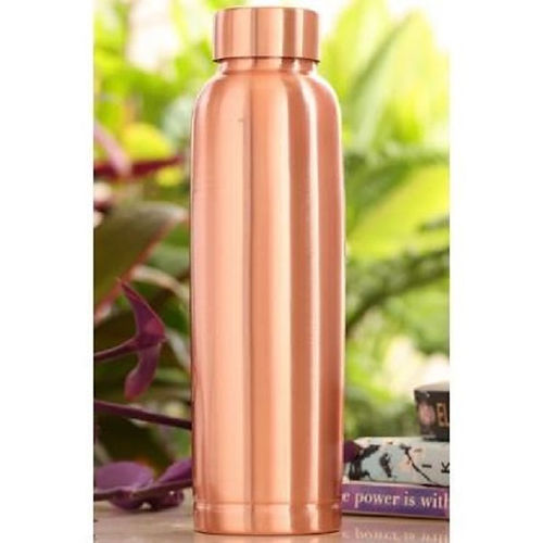 Copper water bottle with a blurred green plant background