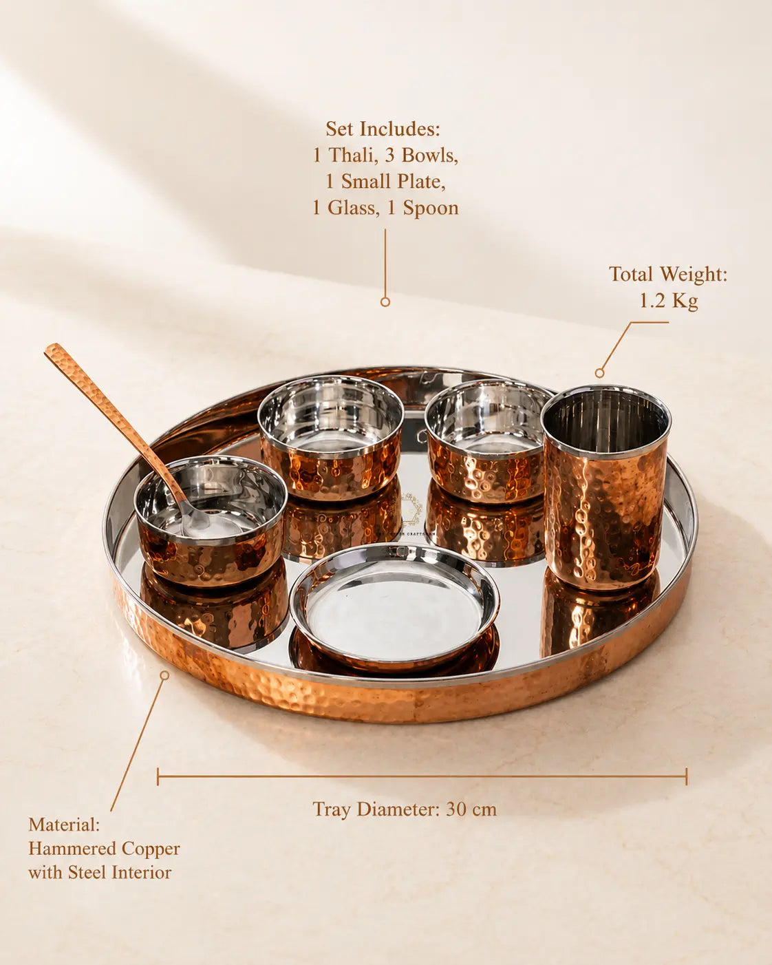 A cCopper Dinner Thali Set with Stainless Steel Interior – 7 Piece serving tray set with bowls, a spoon, and a glass, shown on a beige surface with text callouts detailing the set contents, weight, tray diameter, and material.