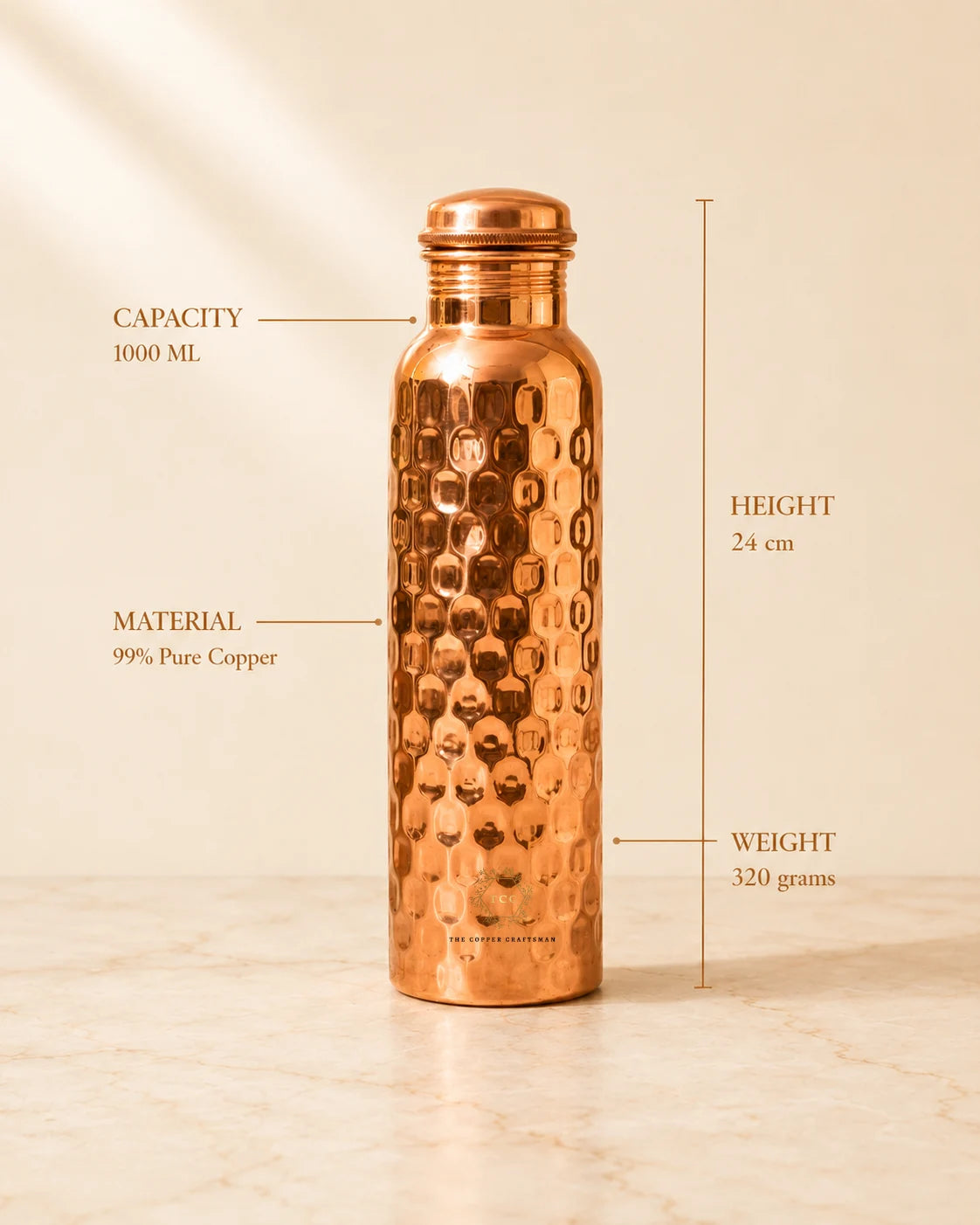 A hammered copper water bottle stands on a light marble surface against a warm beige background. Text callouts indicate capacity 1000 ML, material 99% Pure Copper, height 24 cm, and weight 320 grams.