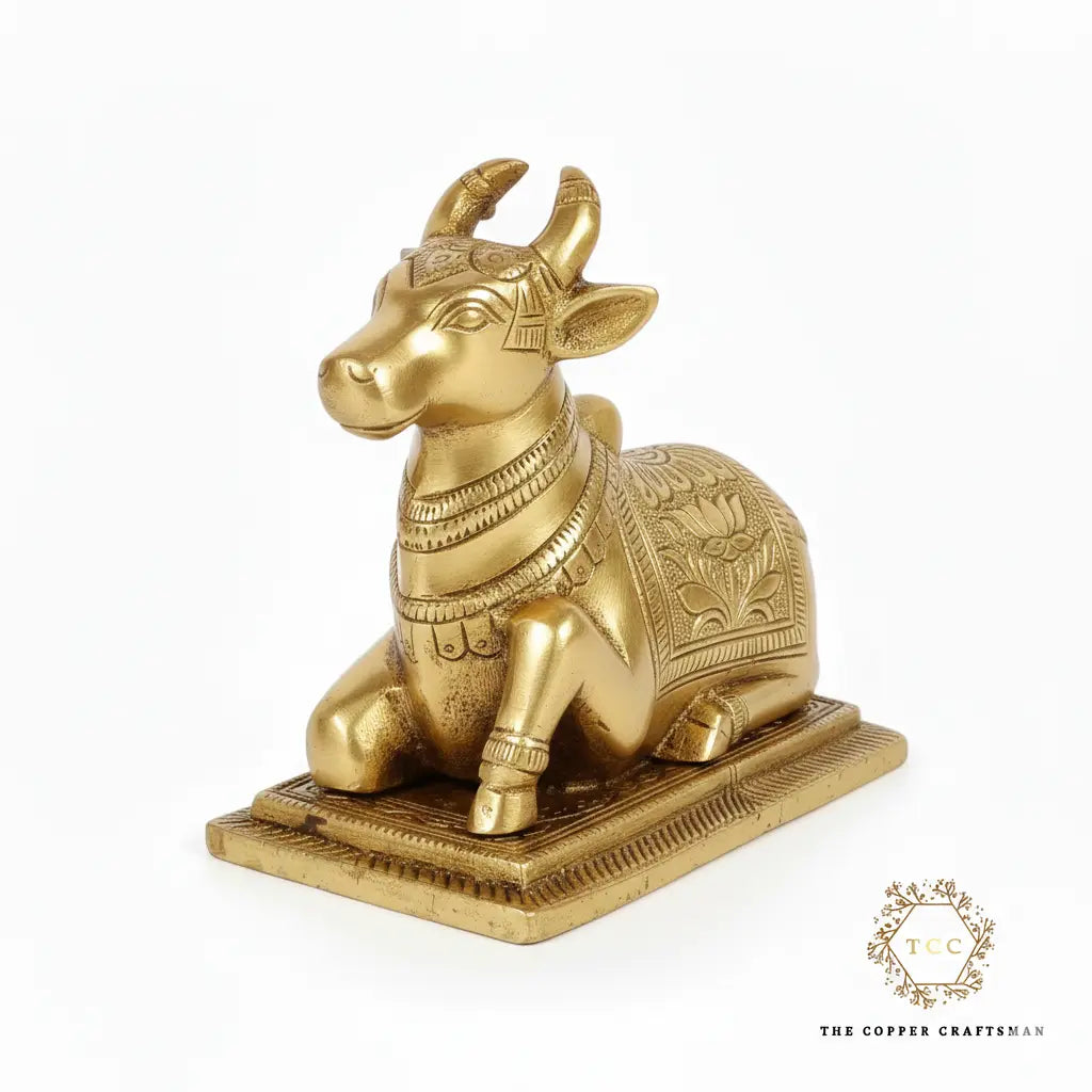 Gold bull statue with intricate designs on a white background