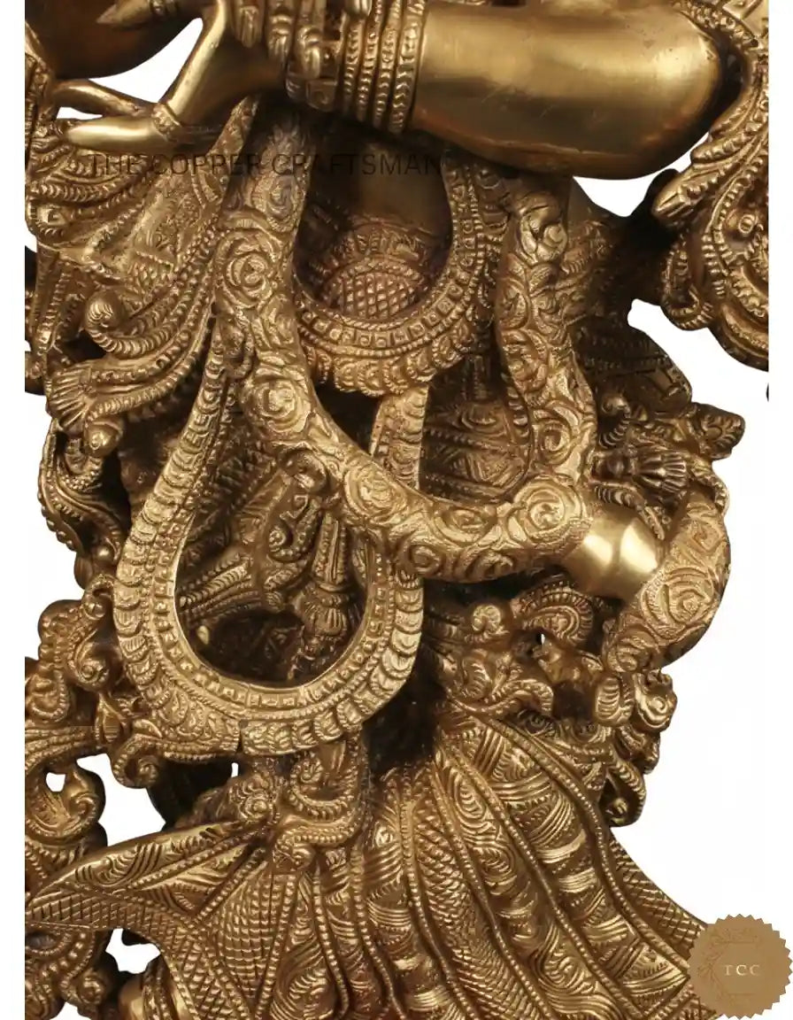 Decorative gold sculpture with intricate designs on a white background