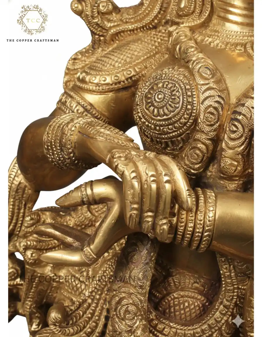 Decorative gold statue with intricate designs on a white background