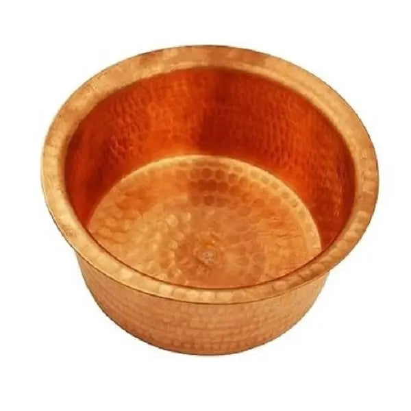 Copper bowl with a textured surface on a white background