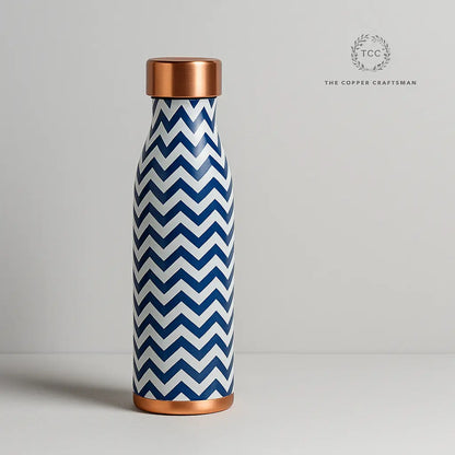 Blue and white chevron patterned water bottle with copper accents on a light gray background