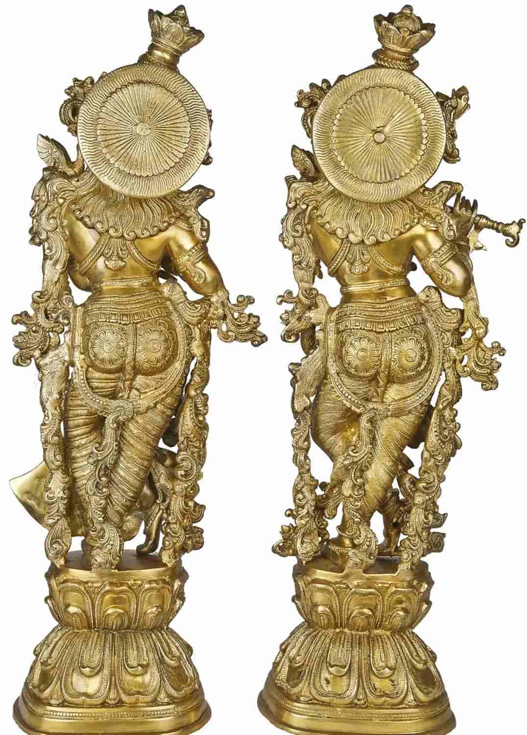 Pair of ornate brass statues on a white background