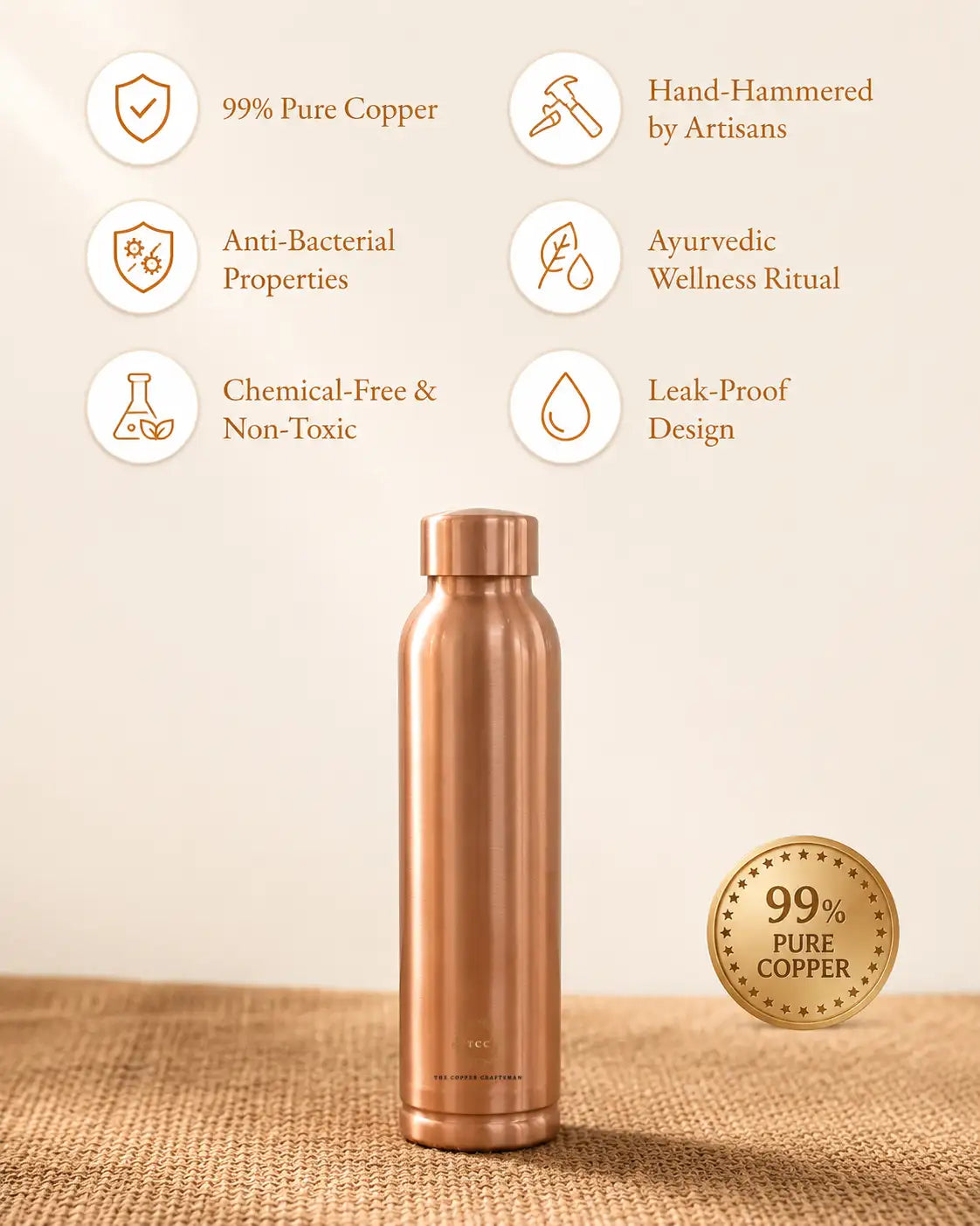 A copper water bottle plain stands on a burlap surface against a warm beige background. Text callouts around the bottle highlight features such as 99% pure copper, hand-hammered craftsmanship, anti-bacterial properties, chemical-free design, leak-proof construction, and an ayurvedic wellness ritual.