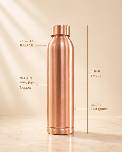 A 1000 mL copper water bottle stands upright on a light beige surface against a warm beige background. Text overlays indicate its material as 99% pure copper, height of 24 cm, and weight of 240 grams.